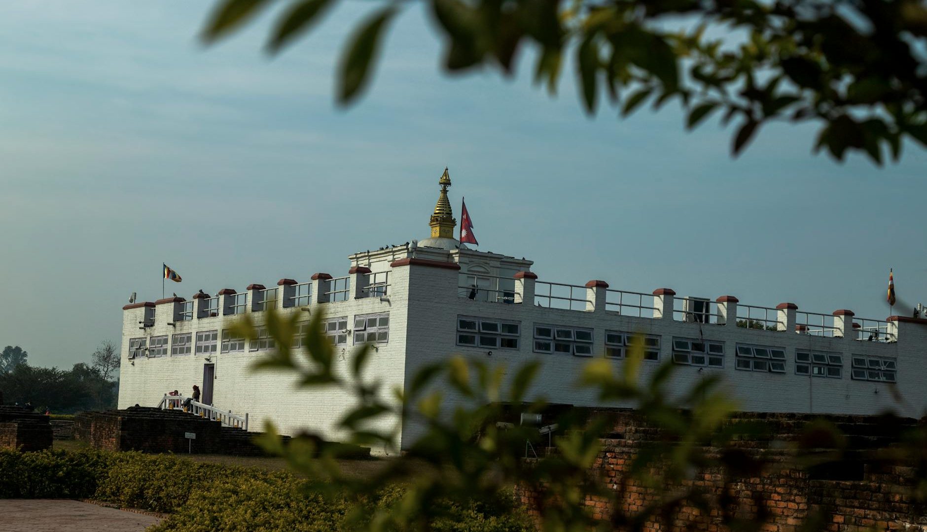View of the Maya Devi Temple, a UNESCO heritage site in Lumbini, Nepal, under clear blue sky.