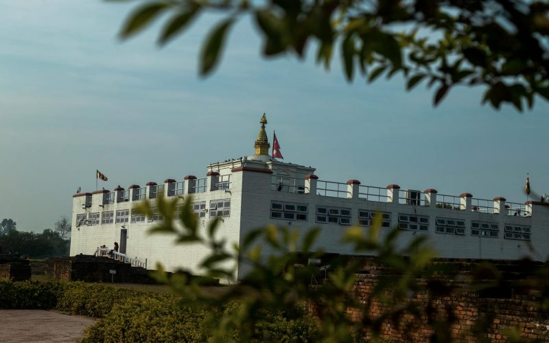 View of the Maya Devi Temple, a UNESCO heritage site in Lumbini, Nepal, under clear blue sky.